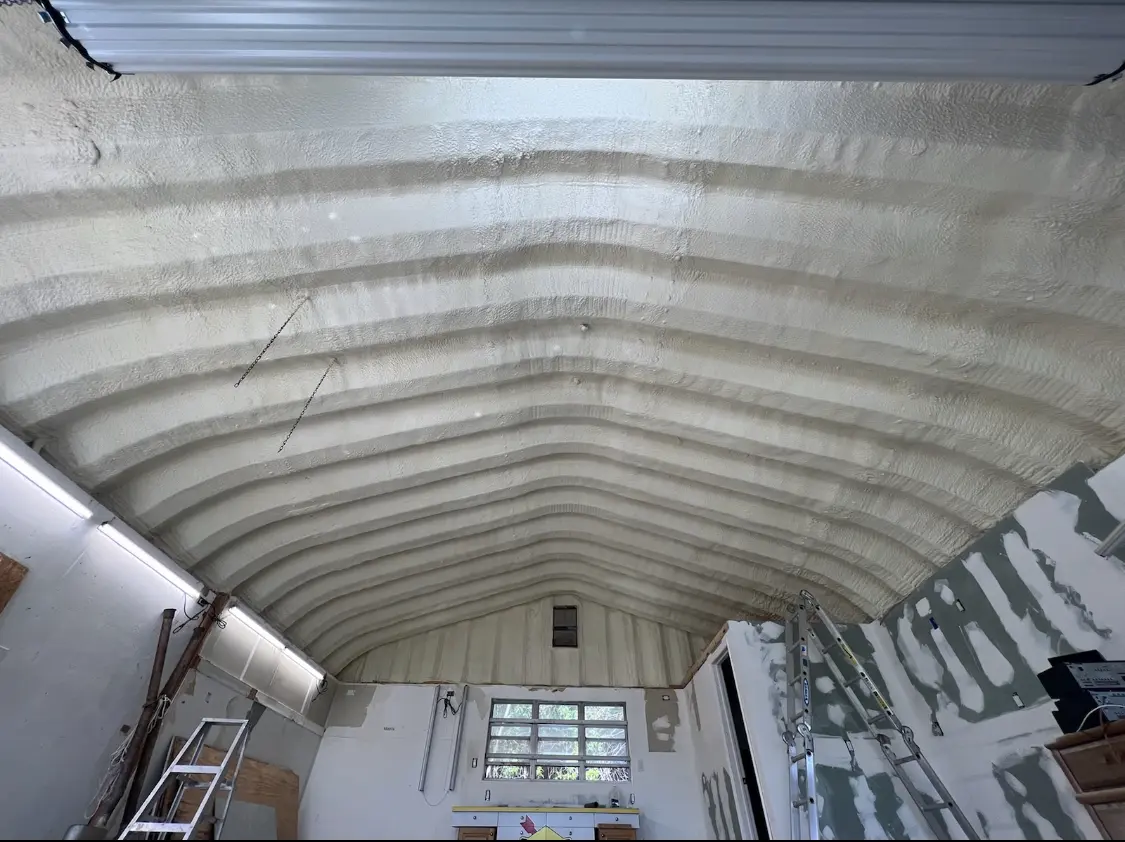 Spray polyurethane foam applied to the underside of a metal roof deck in Denton
